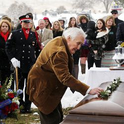 Calvin Shepherd, Jake Shepherd's grandfather, places a flower on his grandson's casket during graveside services in Mendon on Monday, Nov. 28, 2016. Jake Shepherd was one of three crew members of a medical aircraft that crashed just after takeoff on Nov. 18 while transporting a patient from Elko, Nevada, to University Hospital in Salt Lake City. All four people died in the crash.
