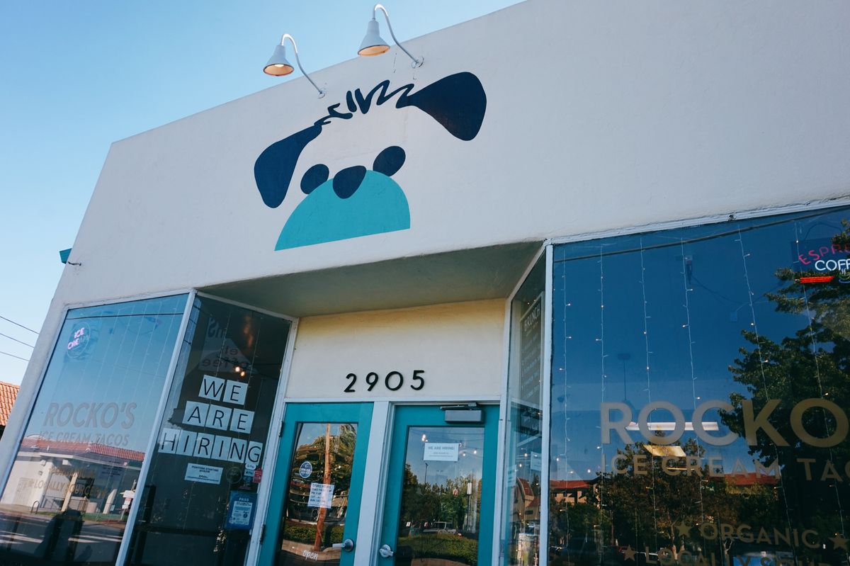 The exterior of Rocko’s Ice Cream Tacos, a white building with a painting of a dog.