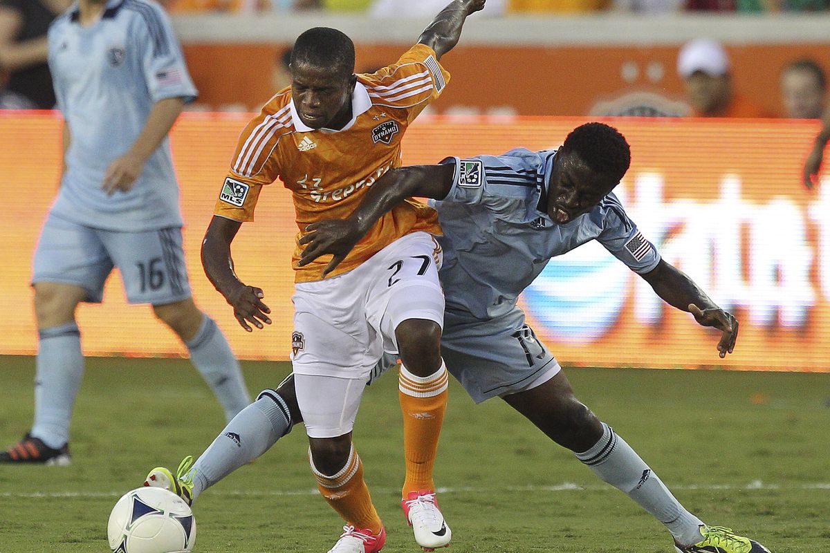 HOUSTON - JULY 18:  Boniek Garcia #27 of the Houston Dynamo keeps the ball away from Peterson Joseph #19 of the Sporting KC in the first half at BBVA Compass Stadium on July 18, 2012 in Houston, Texas.  (Photo by Bob Levey/Getty Images)