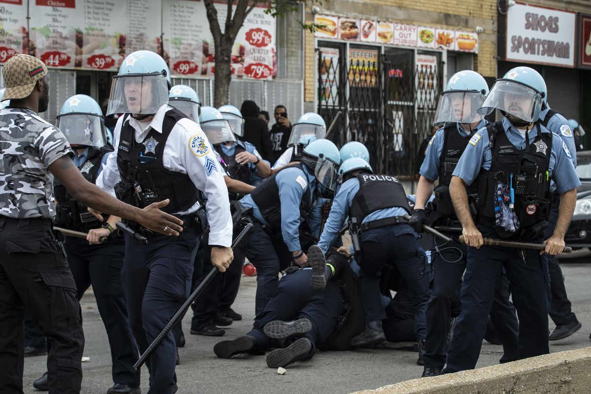 A man is taken into custody on June 1, 2020 as Chicago police officers clash with hundreds of protesters outside a store that had been looted near East 71st Street and South Chappel Avenue.