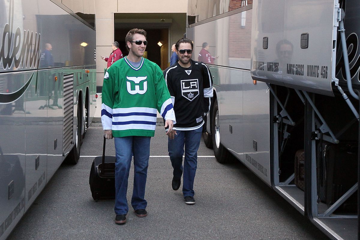 NEW YORK, NY - MAY 17: Jason Bay #44 , wearing a Hartford Whalers NHL jersey, and Mike Nickeas #4 of the New York Mets , wearing a Los Angeles Kings NHL jersey, board the team bus after their game against the Cincinnati Reds at Citi Field on May 17, 