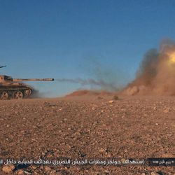 This image posted online on Saturday, Dec. 10, 2016, by supporters of the Islamic State militant group on an anonymous photo sharing website, purports to show a tank operated by the group firing at Syrian troops east of Palmyra city, in Homs provence, Syria. Syrian opposition activists say the Islamic State group has regained control of the ancient town of Palmyra despite a wave of Russian airstrikes in a major advance after a year of setbacks for the group in Syria and Iraq. The Arabic caption reads, "Targeting checkpoints and bases of the Nussayari," a derogative term for for Alawite Syrians, "with tank fire inside the deserted base." 