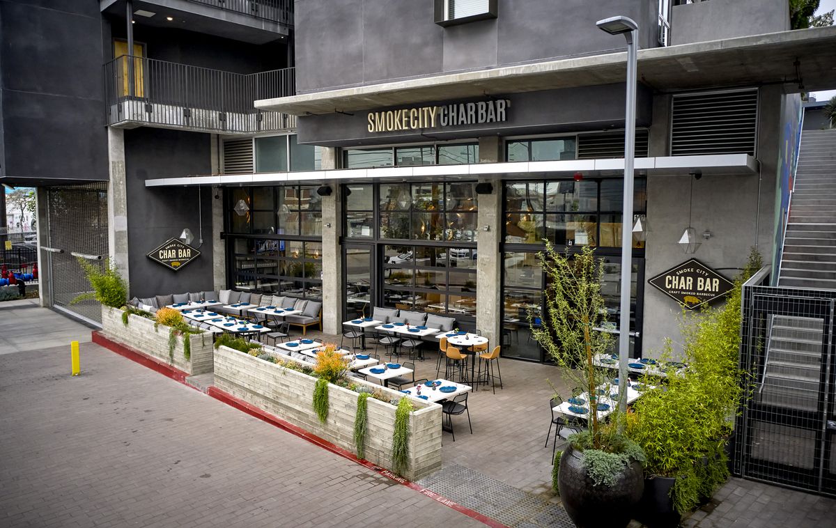A triangle-shaped cement patio at a new restaurant in Los Angeles at daytime.