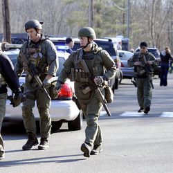 State Police are on scene following a shooting at the Sandy Hook Elementary School in Newtown, Conn., about 60 miles northeast of New York City, Friday, Dec. 14, 2012.