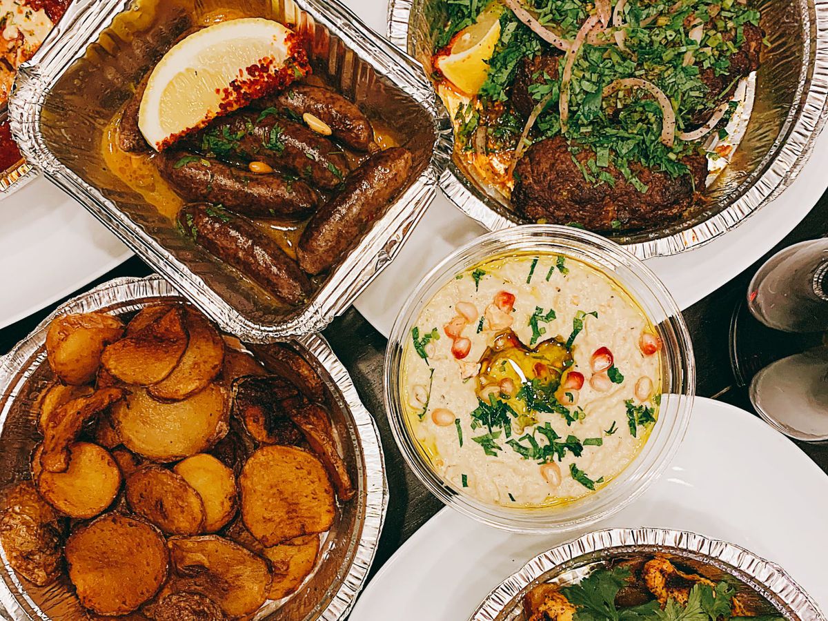 spread of makanek, kefta, batata, baba ghannouj, hummus and djaj méchoui