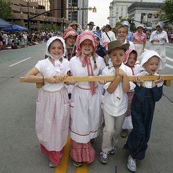 Children with the Sons of Utah Pioneers pull a handcart in the Days of ’47 Parade in Salt Lake City on Wednesday, July 24, 2013.