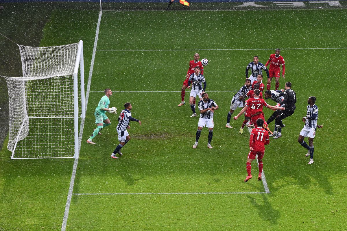 Liverpool’s Brazilian goalkeeper Alisson Becker (2R) scores his team’s second goal during the English Premier League football match between West Bromwich Albion and Liverpool at The Hawthorns stadium in West Bromwich, central England, on May 16, 2021