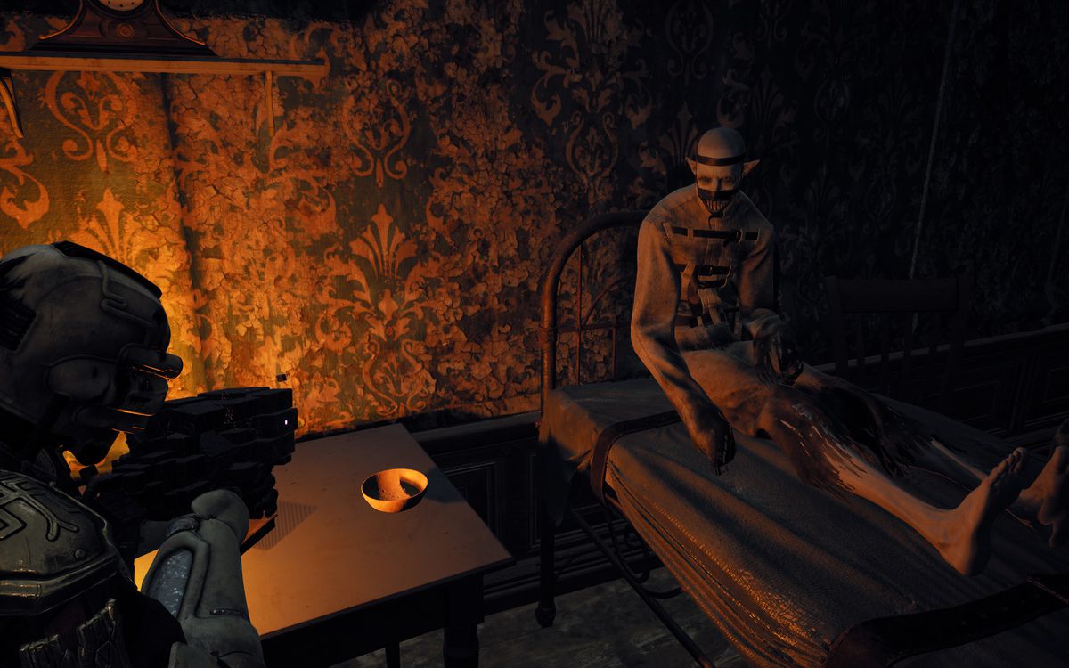The player approaches a patient in the Losomn asylum in Remnant 2, in a room dimly lit by a bedside lamp