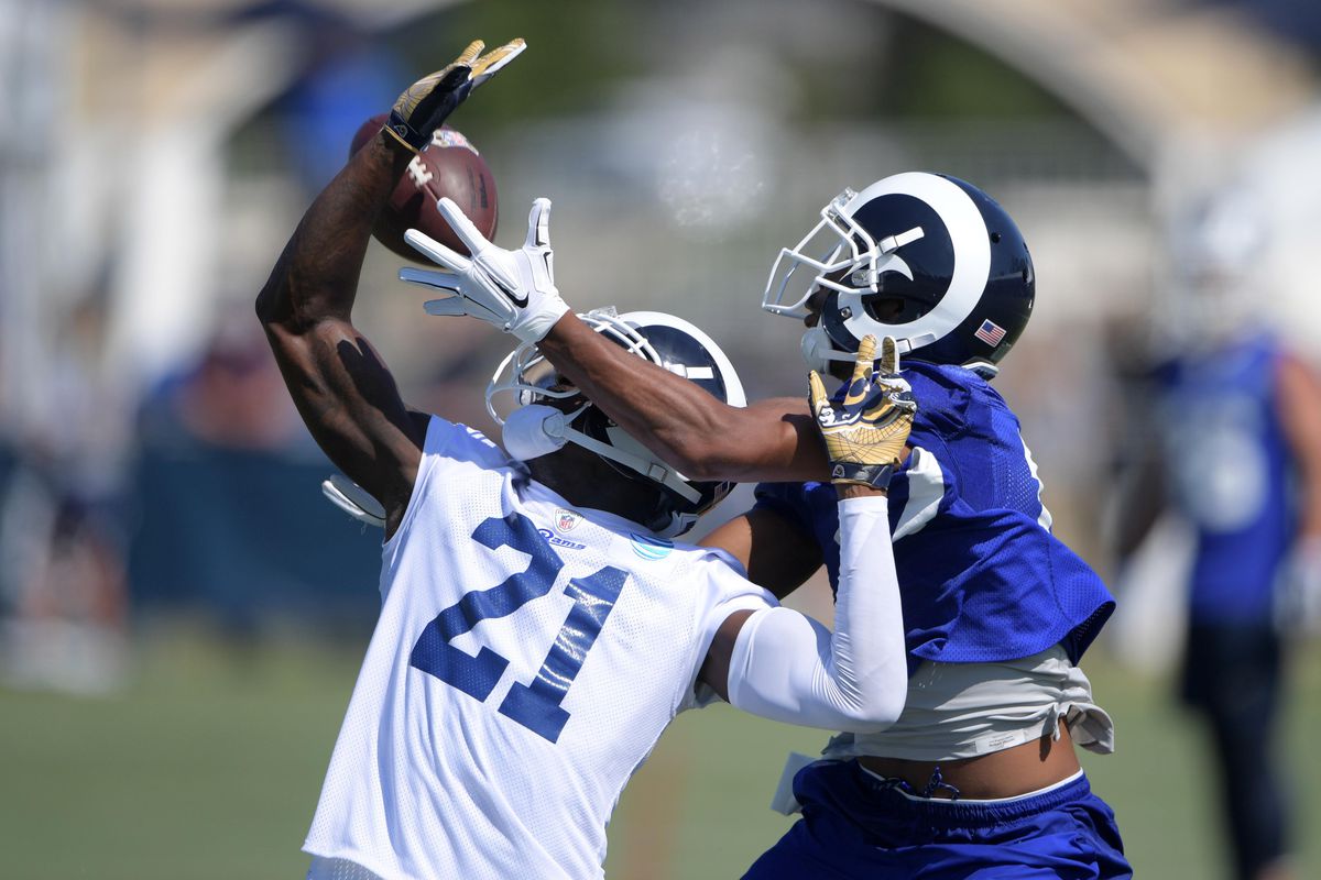 Los Angeles Rams WR Robert Woods tries to bring in a pass against former Rams CB Kayvon Webster during training camp, July 30, 2017.