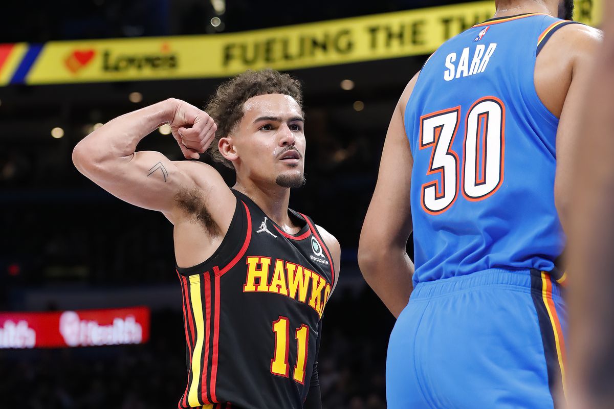 Atlanta Hawks guard Trae Young (11) gestures towards Oklahoma City Thunder center Olivier Sarr (30) after scoring a basket during the first half at Paycom Center.