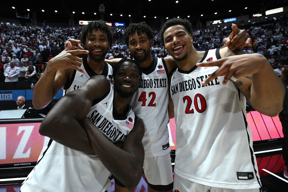 San Diego State Aztecs guard Matt Bradley, forward Nathan Mensah (bottom left), guard Tyler Broughton (left) and guard Triston Broughton pose for a photograph following the victory over the Wyoming Cowboys and earning the Mountain West Conference regular season championship at Viejas Arena.&nbsp;
