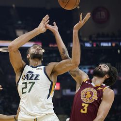 Utah Jazz’s Rudy Gobert (27) and Cleveland Cavaliers’ Ricky Rubio (3) battle for a loose ball in the first half of an NBA basketball game, Sunday, Dec. 5, 2021, in Cleveland. 