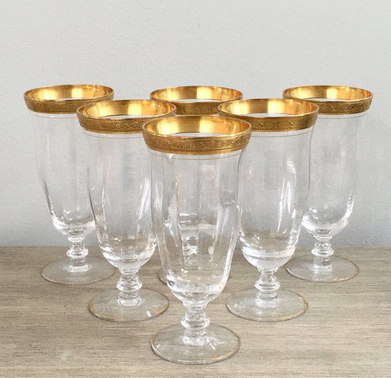 Gold-rimmed vintage glasses on a wooden table