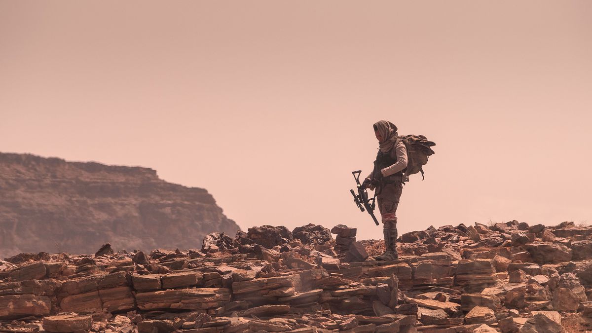 Ismael Cruz Córdova as Jerry stands in a barren Martian landscape in Settlers