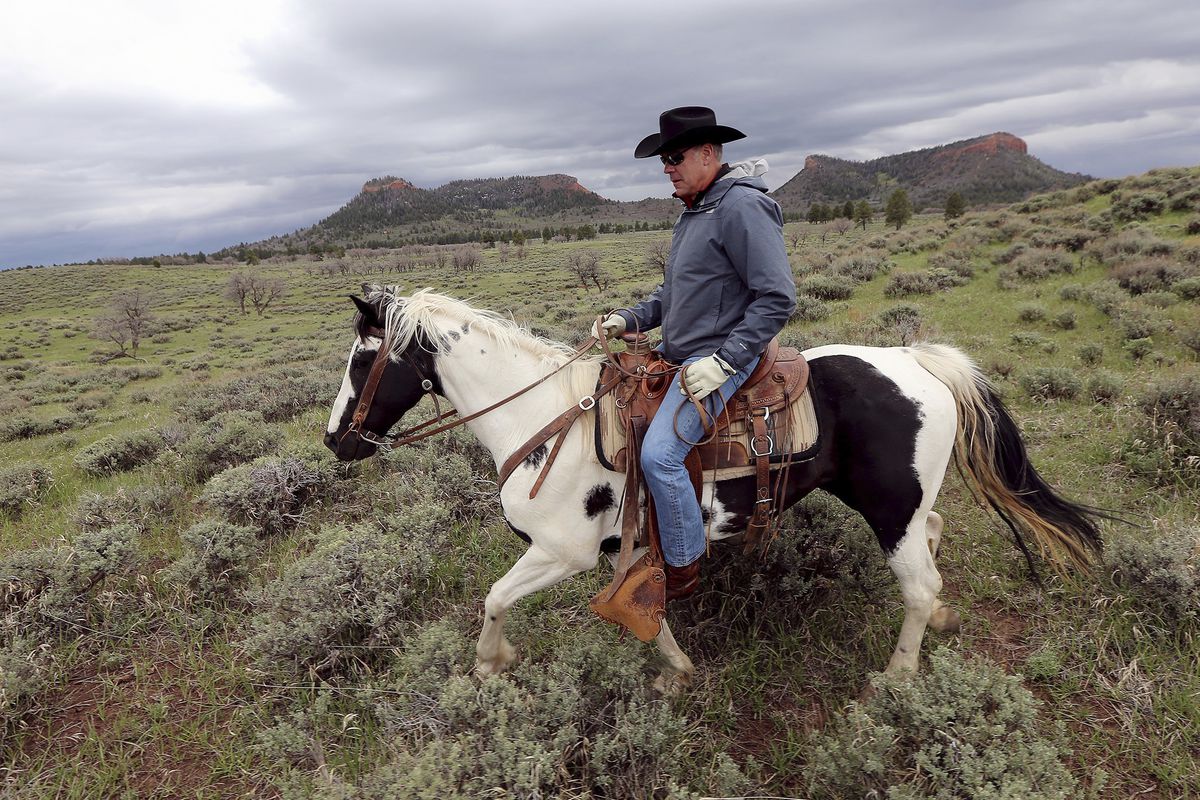FILE - In this May 9, 2017, file photo, Interior Secretary Ryan Zinke rides a horse in the new Bears Ears National Monument near Blanding, Utah. Interior Secretary Ryan Zinke says he is recommending that none of the 27 national monuments under review by t