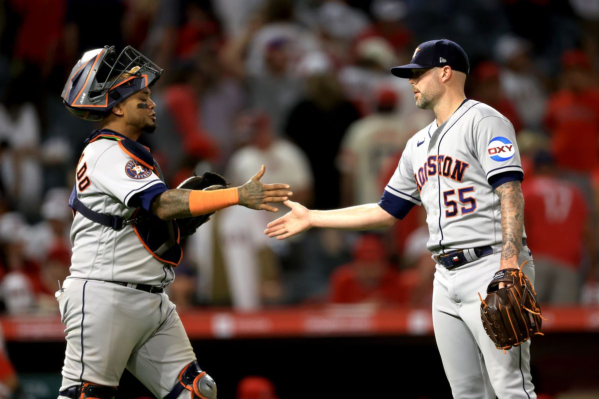 Martin Maldonado celebrates with Ryan Pressly of the Houston Astros after defeating the Los Angeles Angels 7-5 in a game at Angel Stadium of Anaheim on July 14, 2023 in Anaheim, California.