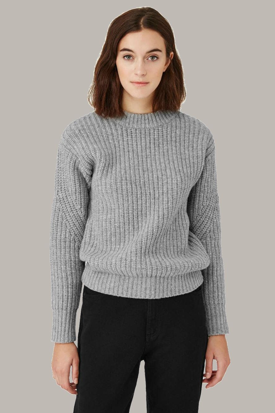 a brunette model in a grey sweater