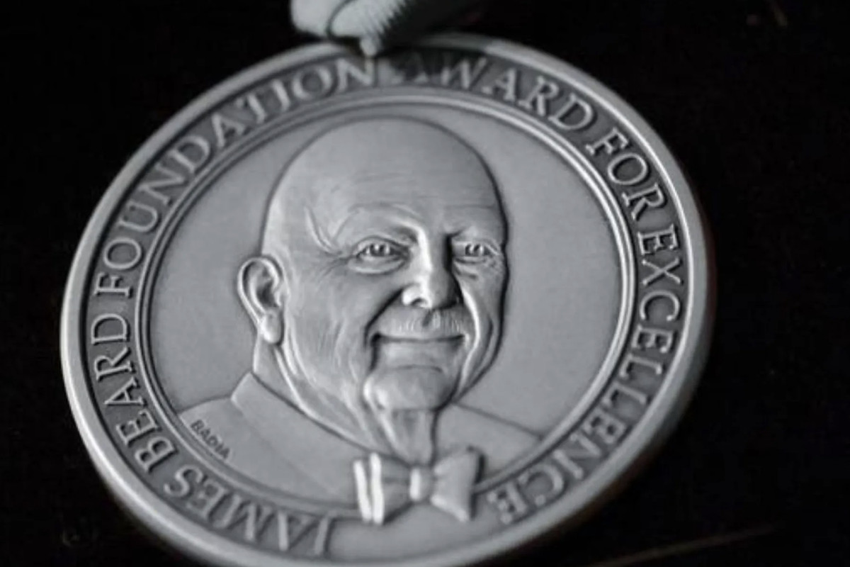 A silver James Beard Award medal.