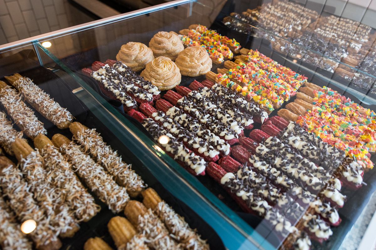 A display glass case full of colorful churros.
