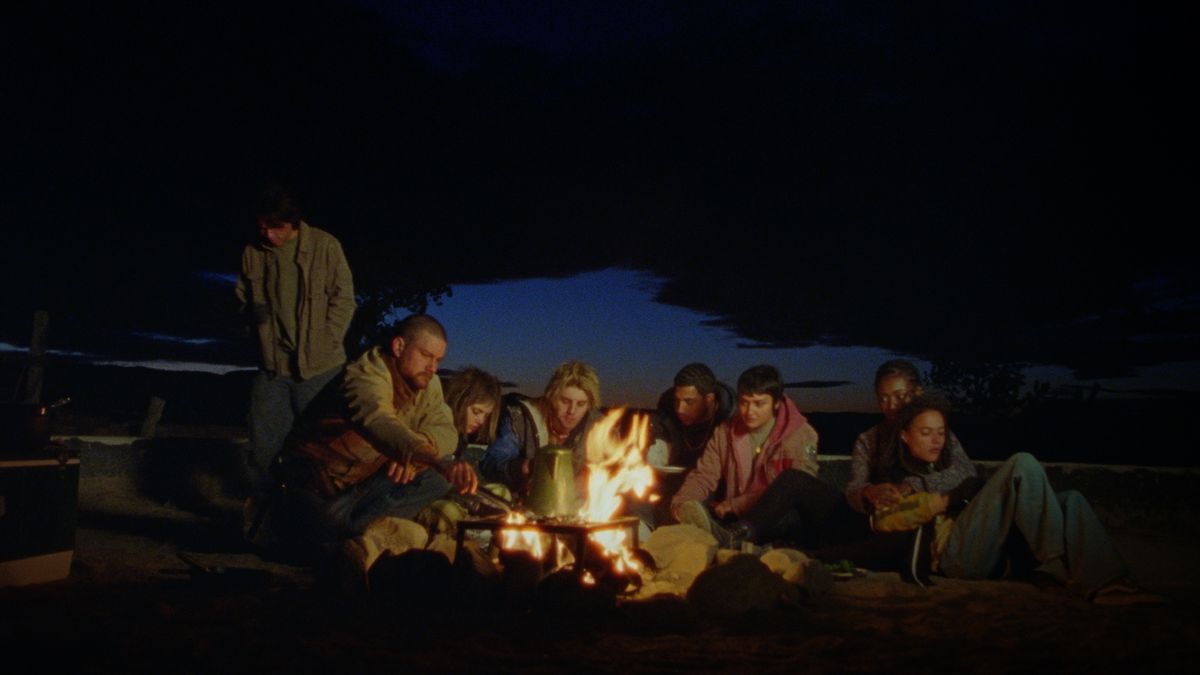 The group of young people huddle around a campfire in How to Blow Up a Pipeline