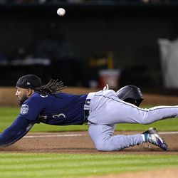 J.P. Crawford #3 of the Seattle Mariners dives into third base safe against the Oakland Athletics in the top of the third inning at RingCentral Coliseum on May 03, 2023 in Oakland, California.
