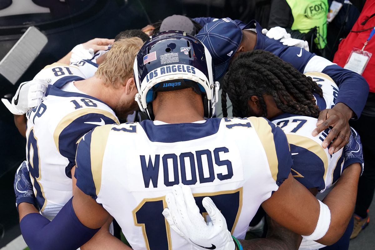 Wide receiver Cooper Kupp #18 and Robert Woods #17 of the Los Angeles Rams huddle with teammates with heads down before the game against the San Francisco 49ers at Levi’s Stadium on December 21, 2019 in Santa Clara, California.