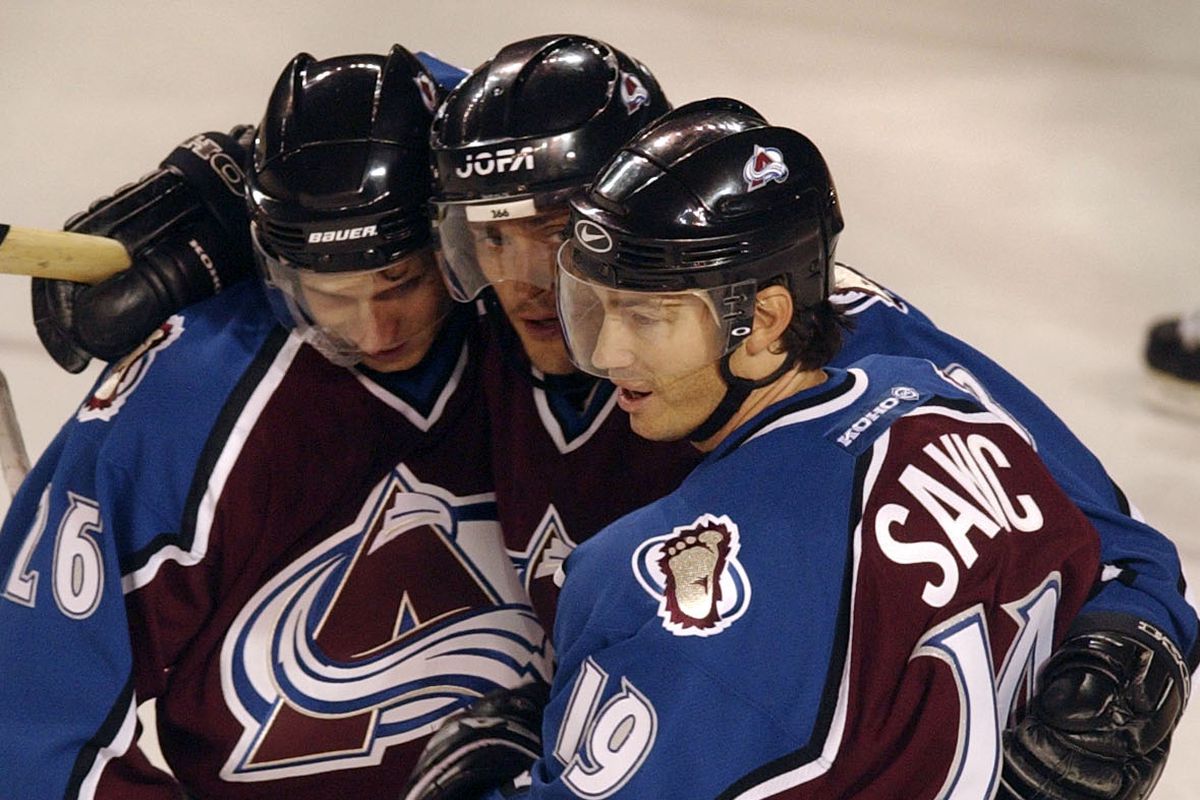 DENVER,CO--SEPTEMBER 16TH 2003--John-Michael  Liles,  #26, left, and Joe  Sakic,  congratulate Teemu  Selanne, center, after Selanne’s second period goal at Magness Areana Tuesday evening. THE DENVER POST/ ANDY CROSS