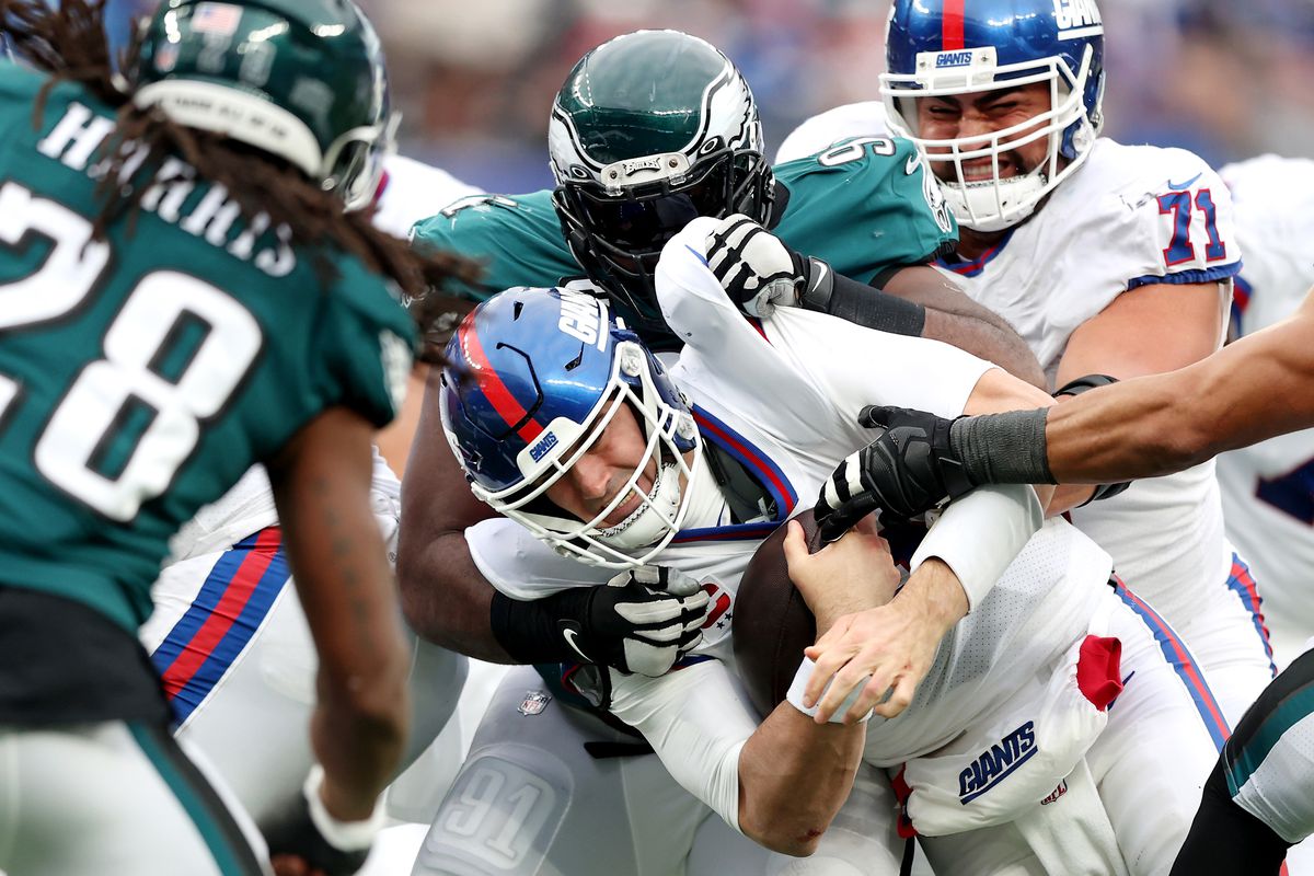 Fletcher Cox #91 of the Philadelphia Eagles tackles Daniel Jones #8 of the New York Giants in the third quarter at MetLife Stadium on November 28, 2021 in East Rutherford, New Jersey.