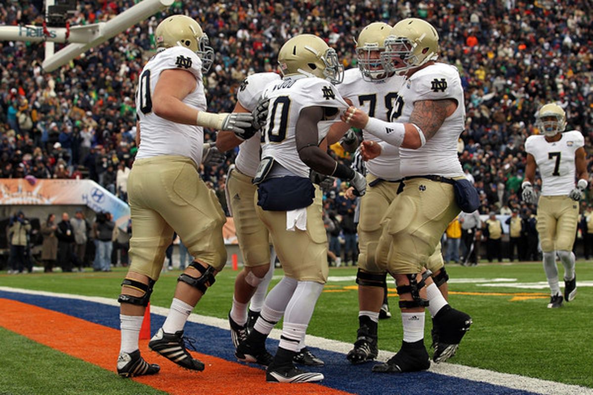 Running back Cierre Wood #20 of the Notre Dame Fighting Irish celebrates a touchdown against the Miami Hurricanes during the Hyundai Sun Bowl at Sun Bowl on December 30 2010 in El Paso Texas.  (Photo by Ronald Martinez/Getty Images)