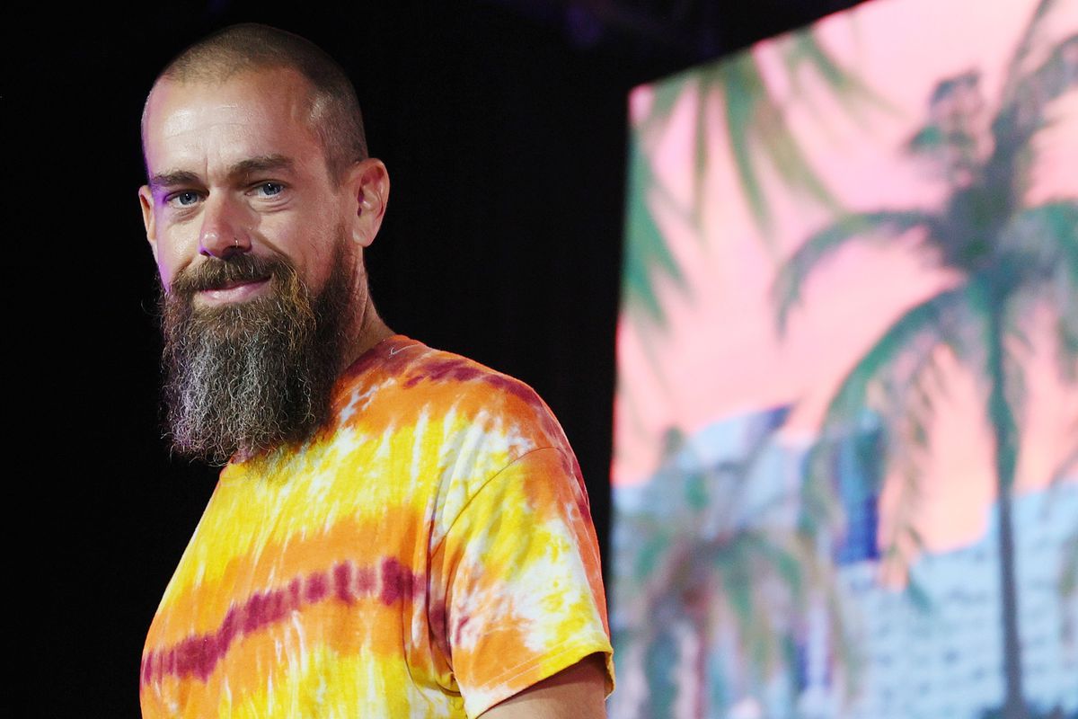 Jack Dorsey with a shaved head and long beard, wearing a tie-dyed shirt.