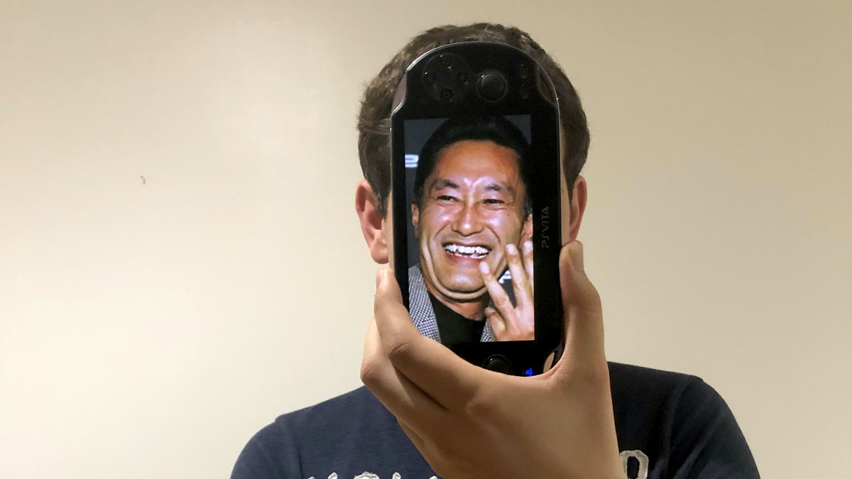 photo of Mark Doherty holding up phone with Kaz Kirai in front of his own face