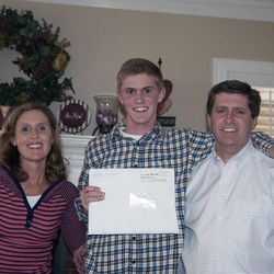 Shelly Shoell; Kaleb Shoell, holding his mission call; and Kevin Shoell
