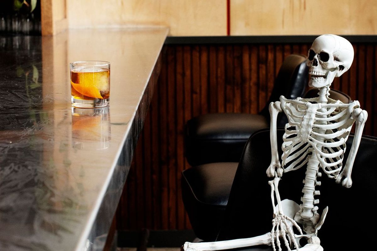 Tattersall Distilling’s bar with a cocktail and skeleton.