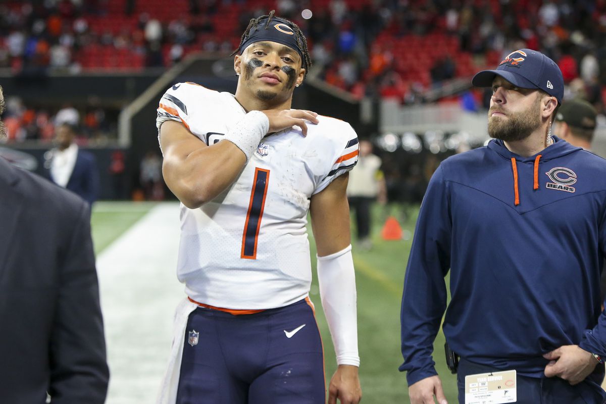 Chicago Bears quarterback Justin Fields (1) walks off the field with medical personnel after a game against the Atlanta Falcons at Mercedes-Benz Stadium.&nbsp;