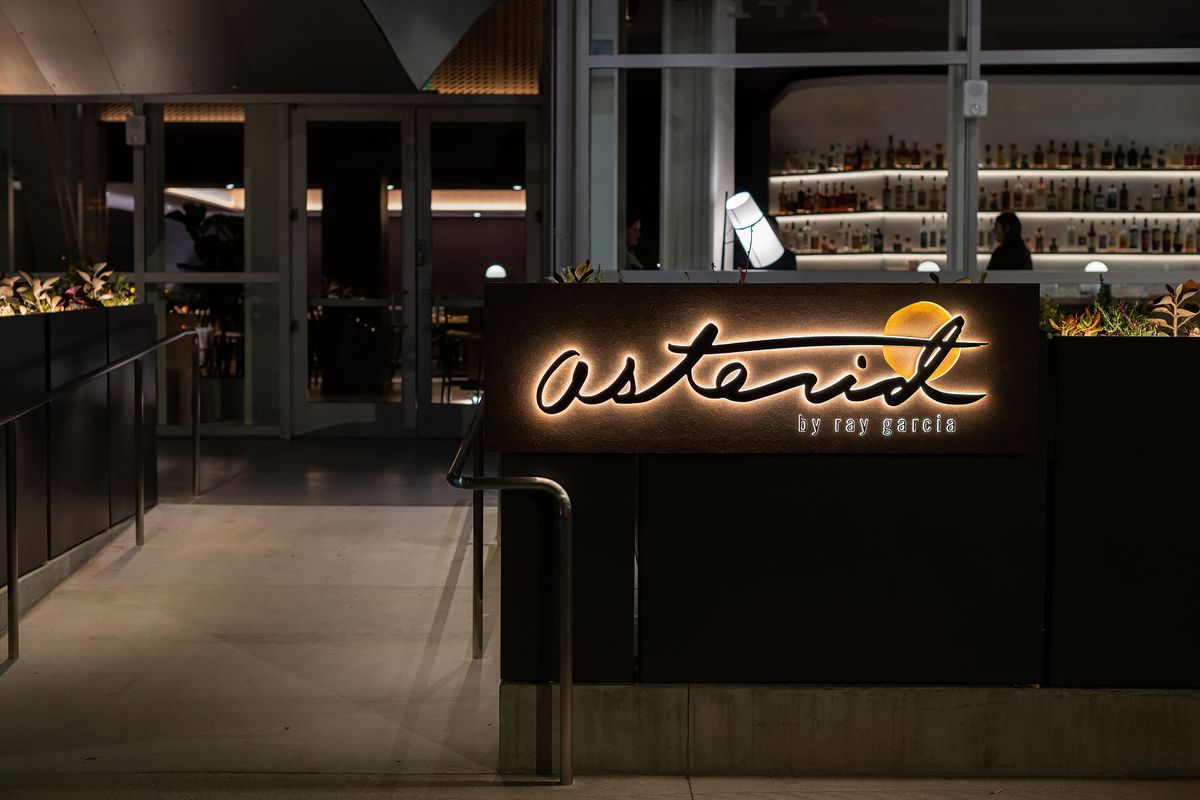 Asterid restaurant entry with glowing signage in Los Angeles.
