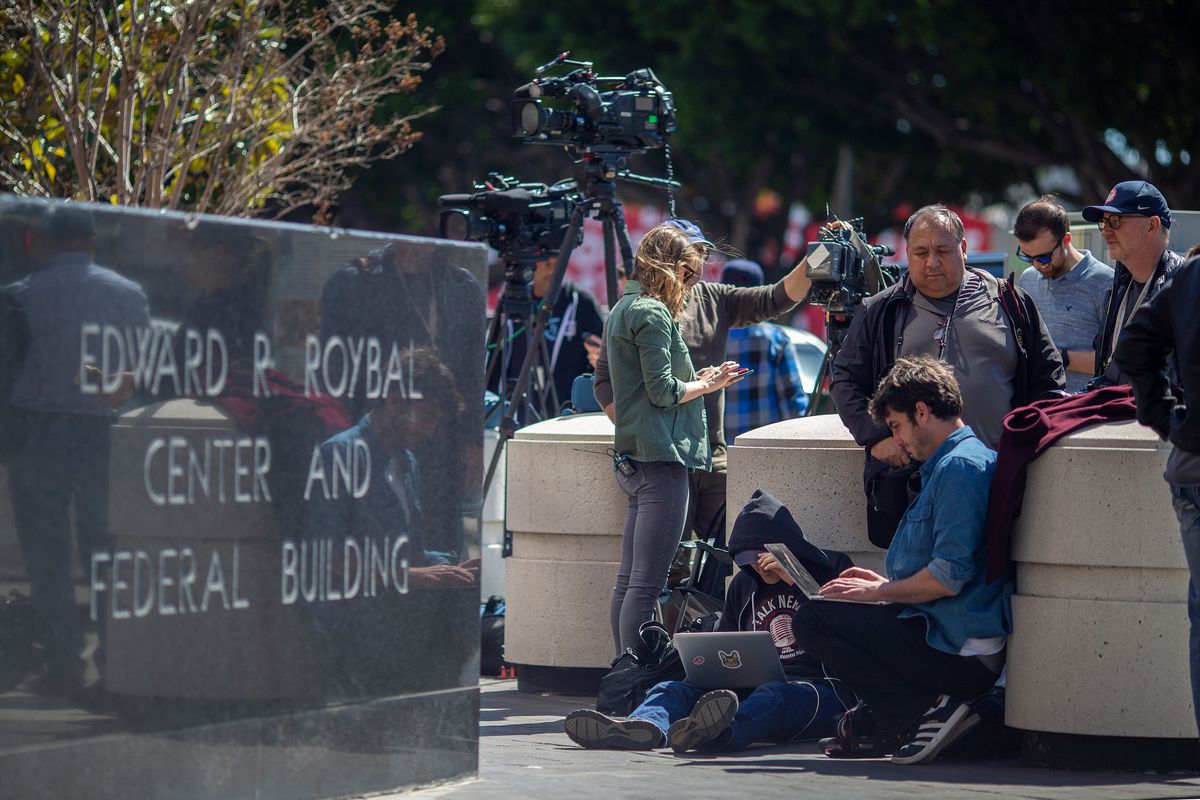 Journalists wait outside a courthouse in Los Angeles, where numerous people had hearings after being arrested on March 12, 2019, in connection with an alleged $25 million nationwide bribery scheme to get students into elite universities.