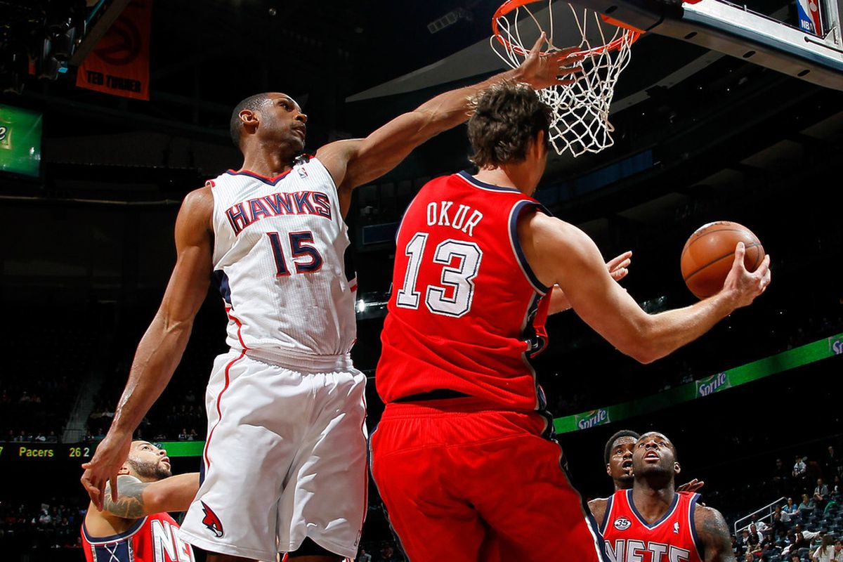ATLANTA, GA - DECEMBER 30:  Al Horford #15 of the Atlanta Hawks defends against Mehmet Okur #13 of the New Jersey Nets at Philips Arena on December 30, 2011 in Atlanta, Georgia.  (Photo by Kevin C. Cox/Getty Images)