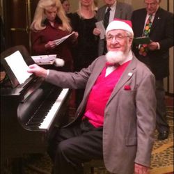 Ardean Watts plays the piano at the Salt Lake Rotary Club's annual Christmas party in 2014.