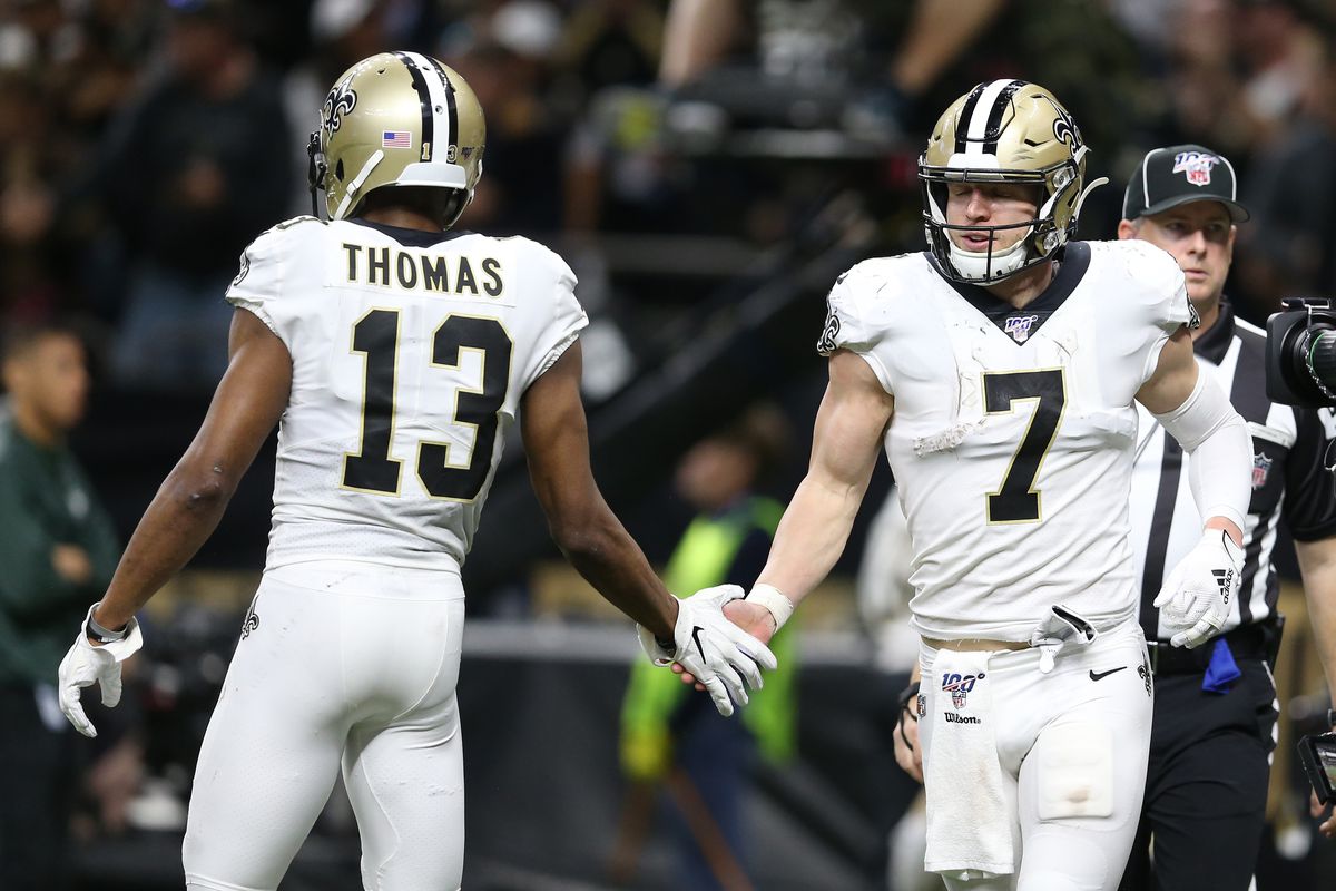 New Orleans Saints quarterback Taysom Hill (7) celebrates with wide receiver Michael Thomas (13) after scoring a touchdown against the Minnesota Vikings during the fourth quarter of a NFC Wild Card playoff football game at the Mercedes-Benz Superdome.&nbsp;