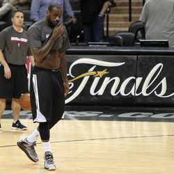 Miami Heat forward LeBron James walks across the court during NBA basketball practice, Saturday, June 15, 2013, in San Antonio. The Heat take on the San Antonio Spurs in Game 5 of the NBA Finals on Sunday, with the best-of-seven games series even at 2-2.