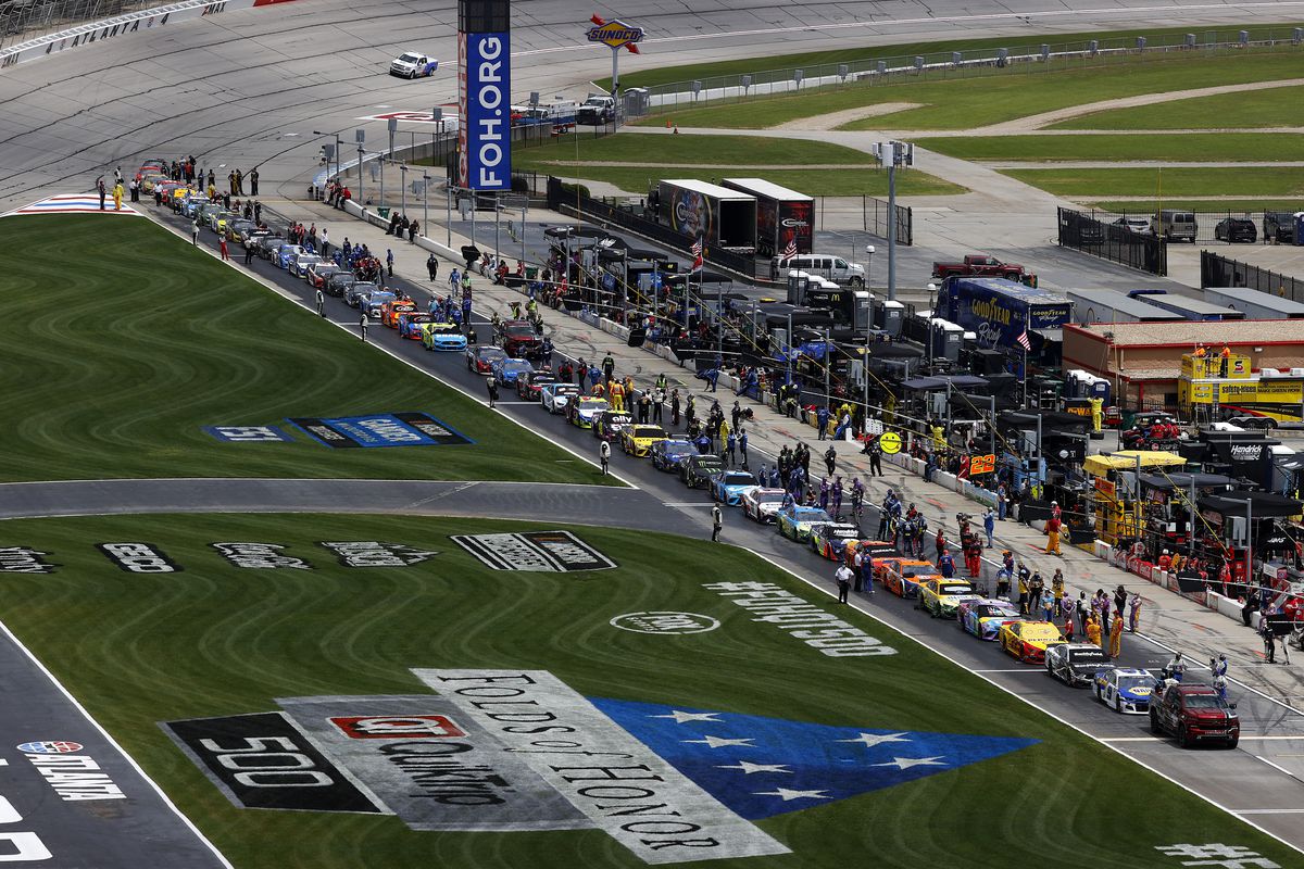 A general view of drivers and crew standing on the grid prior to the NASCAR Cup Series Folds of Honor QuikTrip 500 at Atlanta Motor Speedway on June 07, 2020 in Hampton, Georgia.