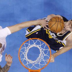 Utah Jazz center Jeff Withey, right, shoots as Oklahoma City Thunder center Steven Adams, left, defends during the second quarter of an NBA basketball game in Oklahoma City, Thursday, March 24, 2016. (AP Photo/Sue Ogrocki)