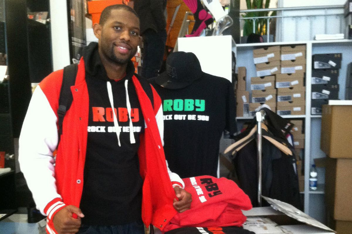 Anderson poses with his ROBY merchandise in a German store