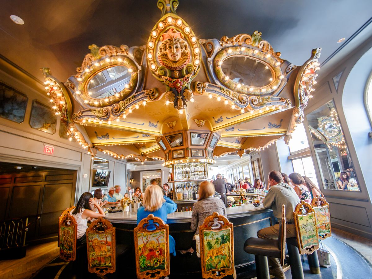 A view of the Carousel Bar, a slowly-rotating bar structure meant to resemble a carousel ride at a carnival, with bulb lights and mirrors. 