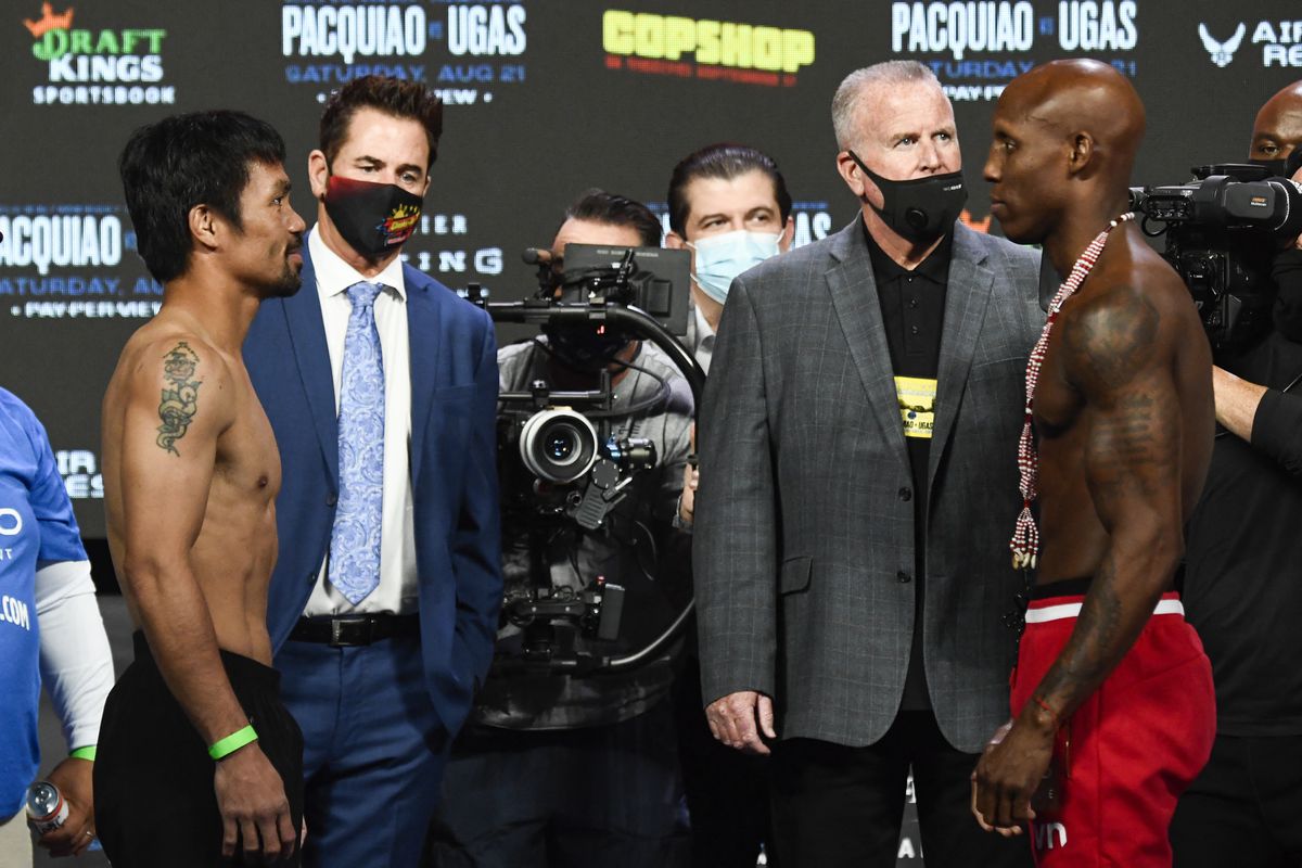 Manny Pacquiao and Yordenis Ugas face off at the weigh-ins in Las Vegas.