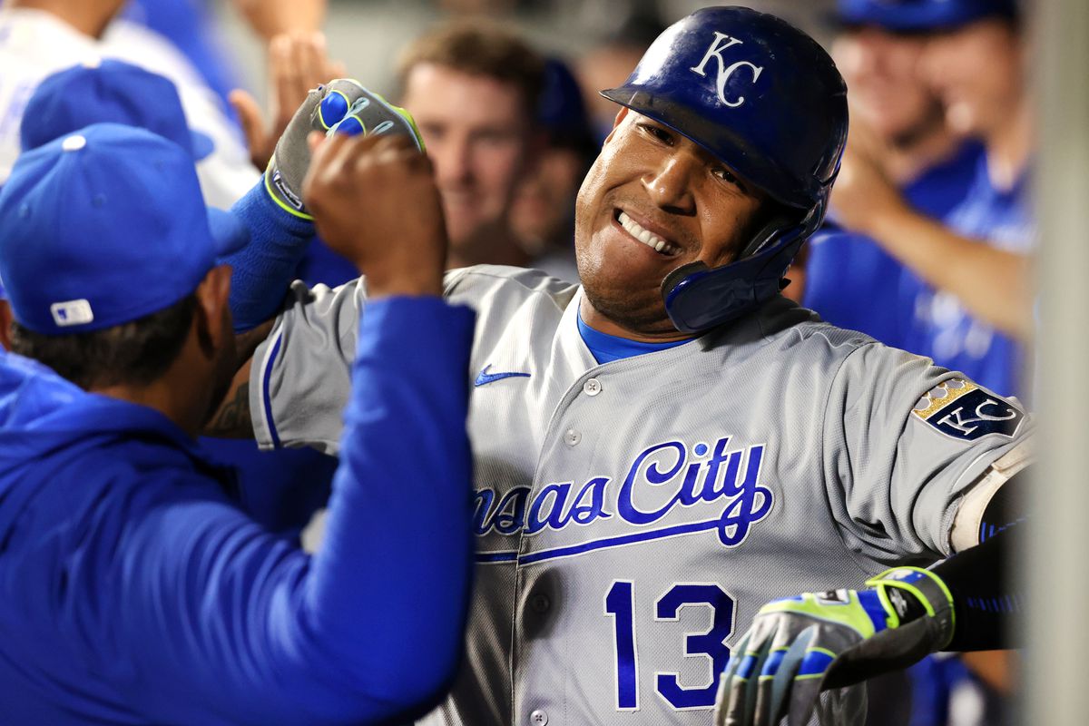 Salvador Perez #13 of the Kansas City Royals celebrates with teammates in the dugout after hitting a grand slam to tie the game 5-5 against the Seattle Mariners in the fifth inning at T-Mobile Park on August 27, 2021 in Seattle, Washington.