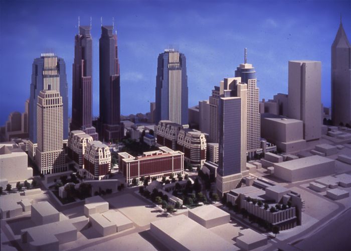 An aerial view of a cityscape with several tall skyscrapers and other shorter city buildings.