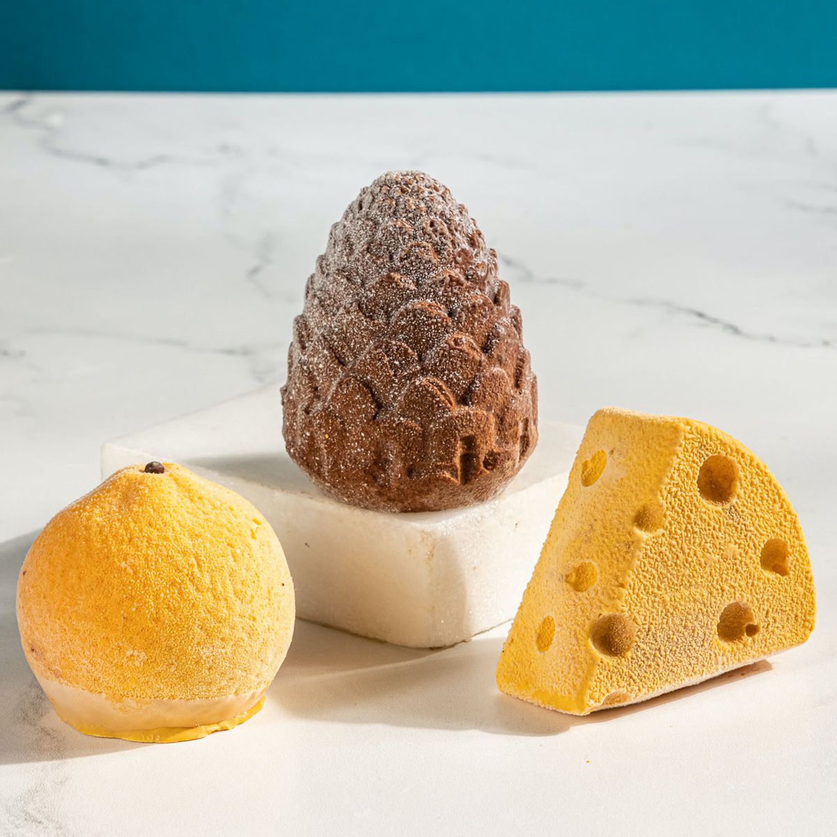 Ice cream shaped like a lemon, pinecone, and wedge of cheese