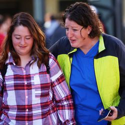Adison Everett and her mother, Gina, walk out of Mountain View High School in Orem after five students were stabbed in an apparent attack by a 16-year-old boy on Tuesday, Nov. 15, 2016.