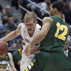 BYU's Tyler Haws drives to the hoop on Avry Holmes as BYU and San Francisco play Saturday, Feb. 9, 2013 in the Marriott Center.